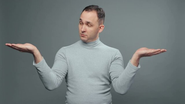 Video of comparing man in turtleneck