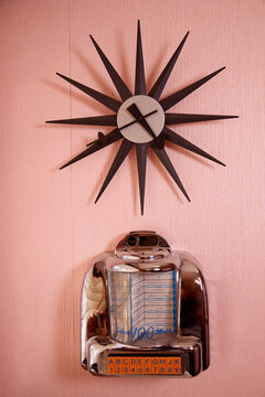 Vintage clock on a pink wall. 
