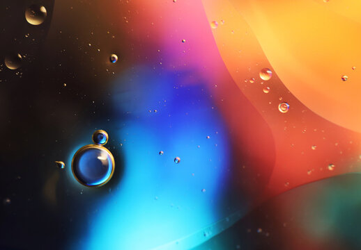 Oil bubbles floating in colored water - Macro