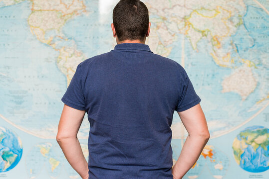 man looking at world map