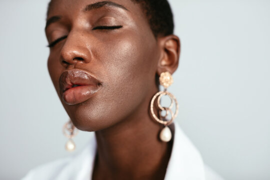 Black woman with plump lips and eyes closed