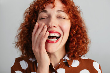 Redhead woman laughing in studio