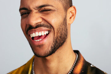 Enthusiastic man winking and smiling at camera