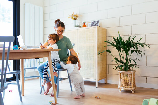 Remote working woman with kids at home