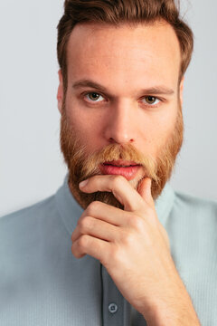 Bearded pensive blonde man in studio