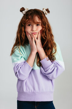 Pretty ginger girl looking away in studio