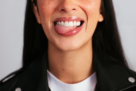Beautiful young woman sticking out the tongue