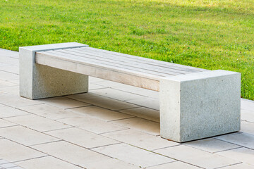 Bench in the city park at evening time.