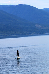 Naklejka premium Paddle boarding in mountain lake 