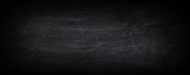 Dark, grunge and scratched chalkboard texture with empty space for text