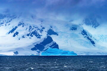 Naklejka na ściany i meble Floating Blue Iceberg Glaciers Charlotte Harbor Antarctica