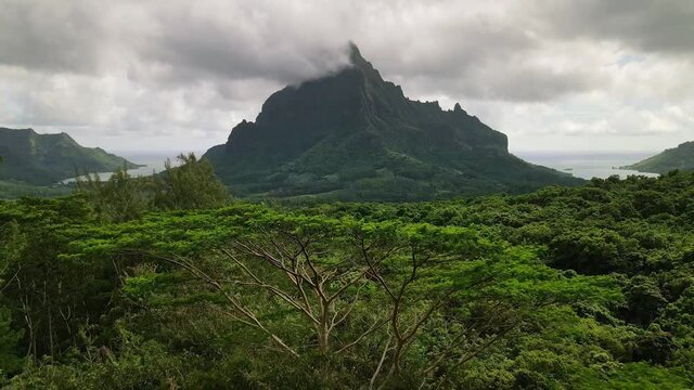 Drone aerial view: Mount Rotui, Moorea, Tahiti French Polynesia. Slow motion. 4k. Paradise vacation & romantic getaway, honeymoon exotic destination. 