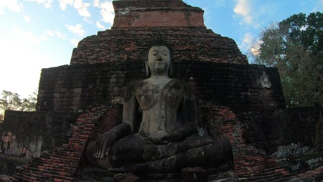 4k Mahathat temple in Sukhothai historical park;Thailand.Seated Buddha(Phra Atchana) at Wat Si Chum temple in Sukhothai Historical Park; a UNESCO world heritage site; Thailand.