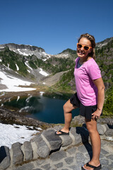 Happy woman tourist poses at Heather Meadows in Mt Baker National Recreation area, Washington