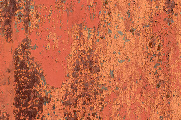 Metal surface with old multi-layer backdrop paint. The main paint color is Japonica, Sandy Brown, blue. Cracking, delamination, areas of rust.