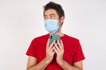 Copyspace photo of  Young caucasian man with short hair wearing medical mask standing  pretty attractive gorgeous sweet lovely beautiful boyfriend stupor with something occurring in social media