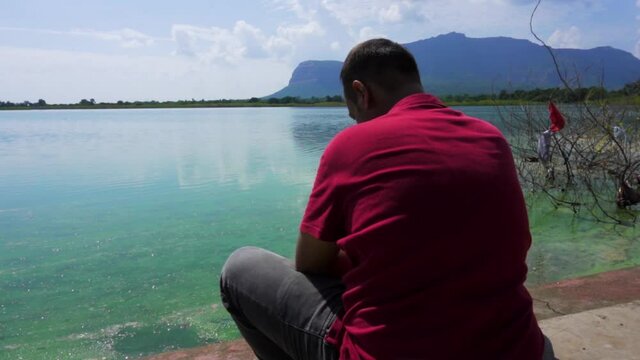 man at Vadatalav lake. man enjoying nature and pavagadh mountain