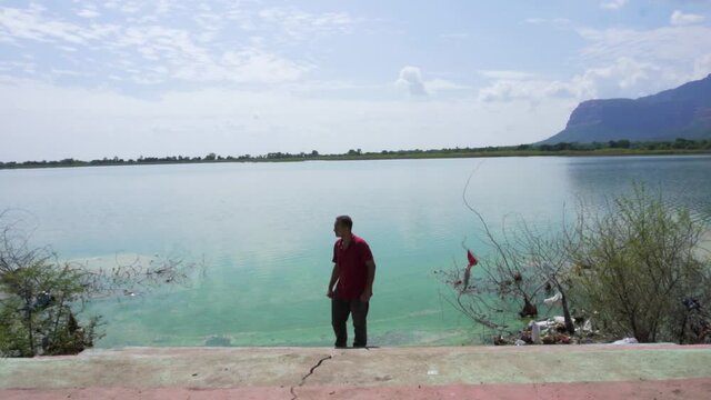 man at Vadatalav lake. man enjoying nature and pavagadh mountain