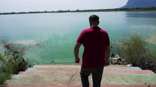 man at Vadatalav lake. man enjoying nature and pavagadh mountain