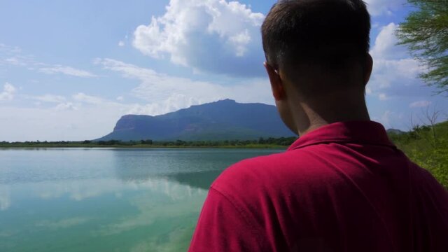 man at Vadatalav lake. man enjoying nature and pavagadh mountain