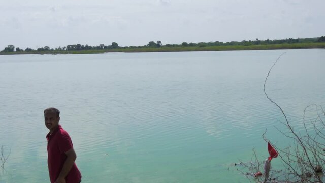 man at Vadatalav lake. man enjoying nature and pavagadh mountain