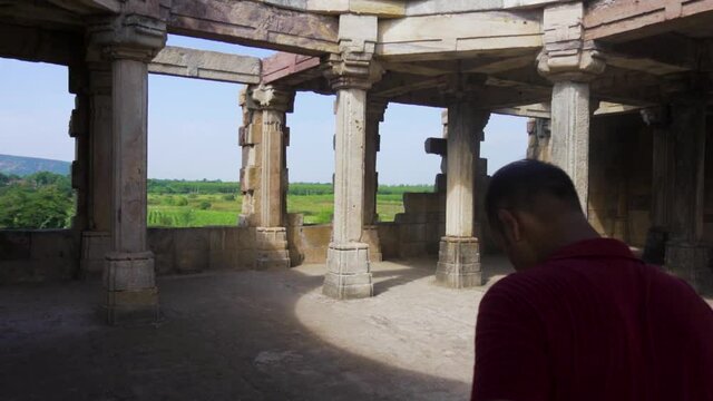 Young guy exploring world heritage Kabutar khana Pavilion also known as khajuri mosque