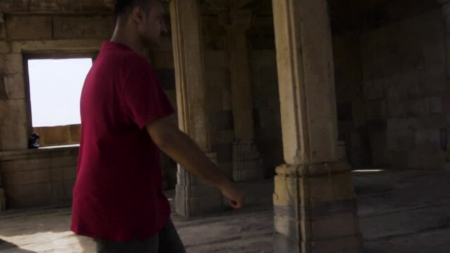 Young guy exploring world heritage Kabutar khana Pavilion also known as khajuri mosque