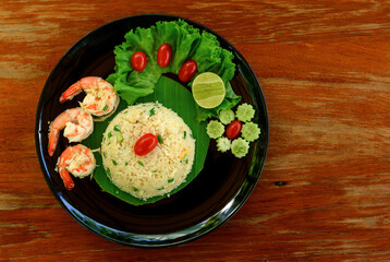 Top view of fried rice with shrimp on black dish