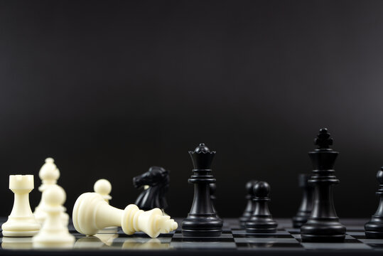 Black chess team win over white chess team for business winning concept