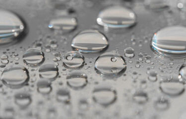 Macro photography of water drops on a mirror reflective surface. Concept of a couple in love and relationship