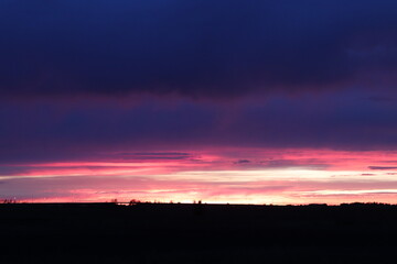 vibrant sunset silhouette on a shadowy prarie