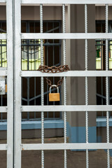 Padlock with chain on iron door in women's prison, deprived of liberty.