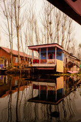 Boathouses and rowboats on Lake Dal in Srinagar, northern India.A smoky lake without wind is a mirror.