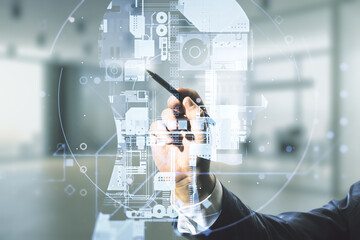 Double exposure of man hand with pen working with creative artificial Intelligence hologram on blurred office background. Neural networks and machine learning concept