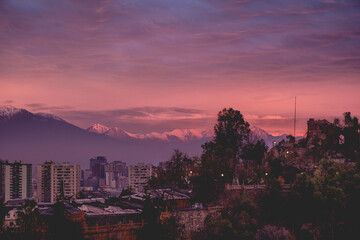 Scenic view of beautiful clouds and sunset sky over Santiago, Santa Lucía Hill and The Andes Mountains, Chile	