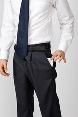 torso of businessman turning his empty pockets inside out