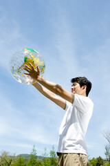 young man holding a globe
