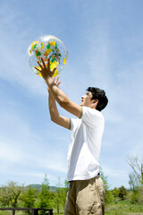 young man holding a globe