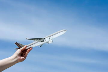arm holding a toy plane