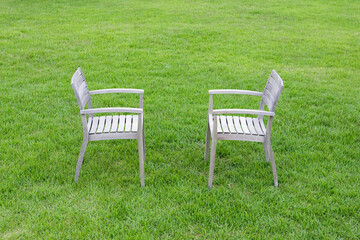 wooden chairs on grass