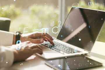 Creative scientific formula hologram with hands typing on computer keyboard on background, research...