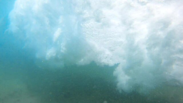 Ocean Wave Crashing and Curling Underwater