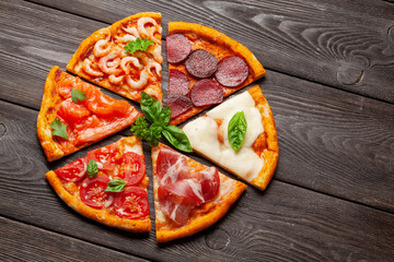 Tasty slices of different pizza