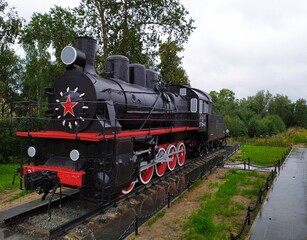 Vintage military black steam locomotive on rails