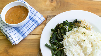 Nasi Pecel. Traditional Javanese rice dish of steamed rice with vegetable salad, peanut dressing, tempeh, beancurd and crackers.
