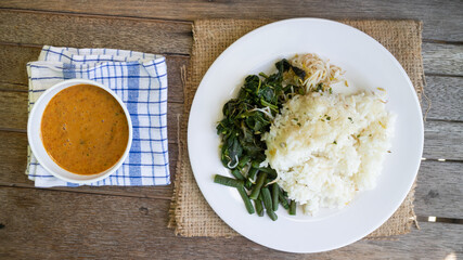 Nasi Pecel. Traditional Javanese rice dish of steamed rice with vegetable salad, peanut dressing, tempeh, beancurd and crackers.