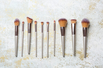Set of makeup brushes on light background