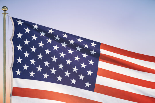 US flag on sunset sky background, close up