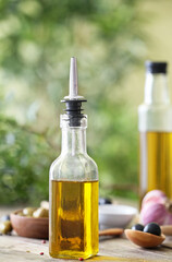 Bottle of olive oil on table outdoors
