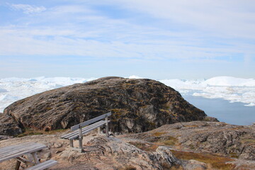 Rustic outdoor furniture overlooking the Ilulissat Icefjord, Ilulissat, Greenland.